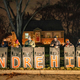 People hold shields spelling Andre Hill’s name as they participate in a call to action “White People Stop Calling the Cops on Black People” protest hosted by Showing Up for Racial Justice Columbus(SURJ) in front of the house of the neighbor who called the police on Andre Hill the night he was shot and killed in Columbus, Ohio on December 28, 2020.